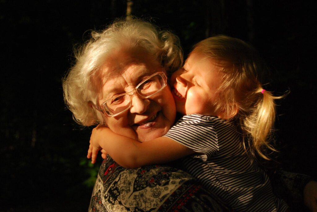 Image via Unsplash - grandmother and grandchild hugging