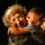 Image via Unsplash - grandmother and grandchild hugging