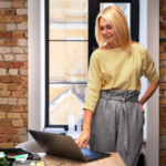 woman at laptop in brick room